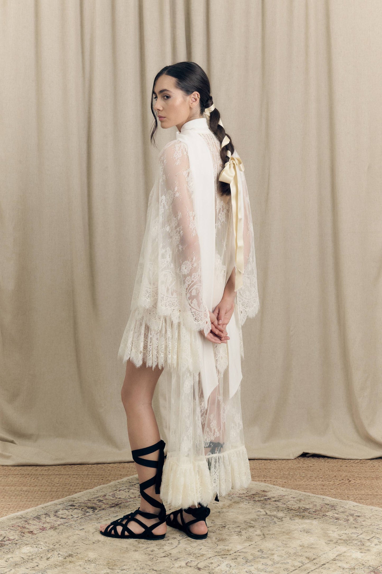 Model wearing Botteghe Oscure asymmetrical French Chantilly lace dress with silk scarf – side view