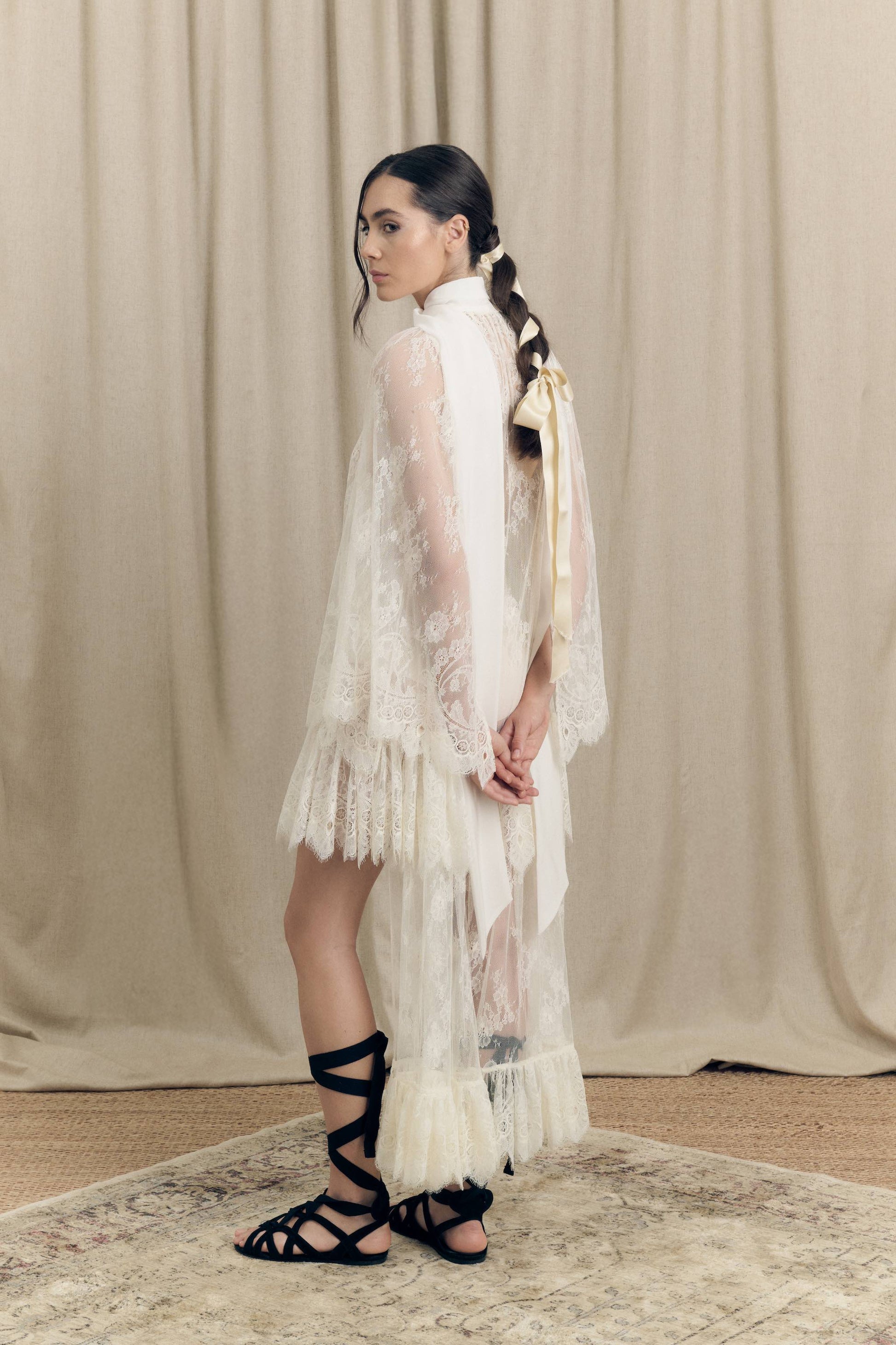 Model wearing Botteghe Oscure asymmetrical French Chantilly lace dress with silk scarf – side view