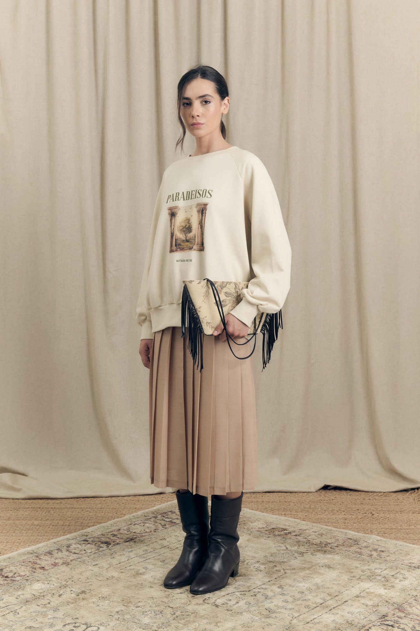 Model wearing oversized sweatshirt by Botteghe Oscure featuing exclusive Paradeisos print and embroidered lettering 