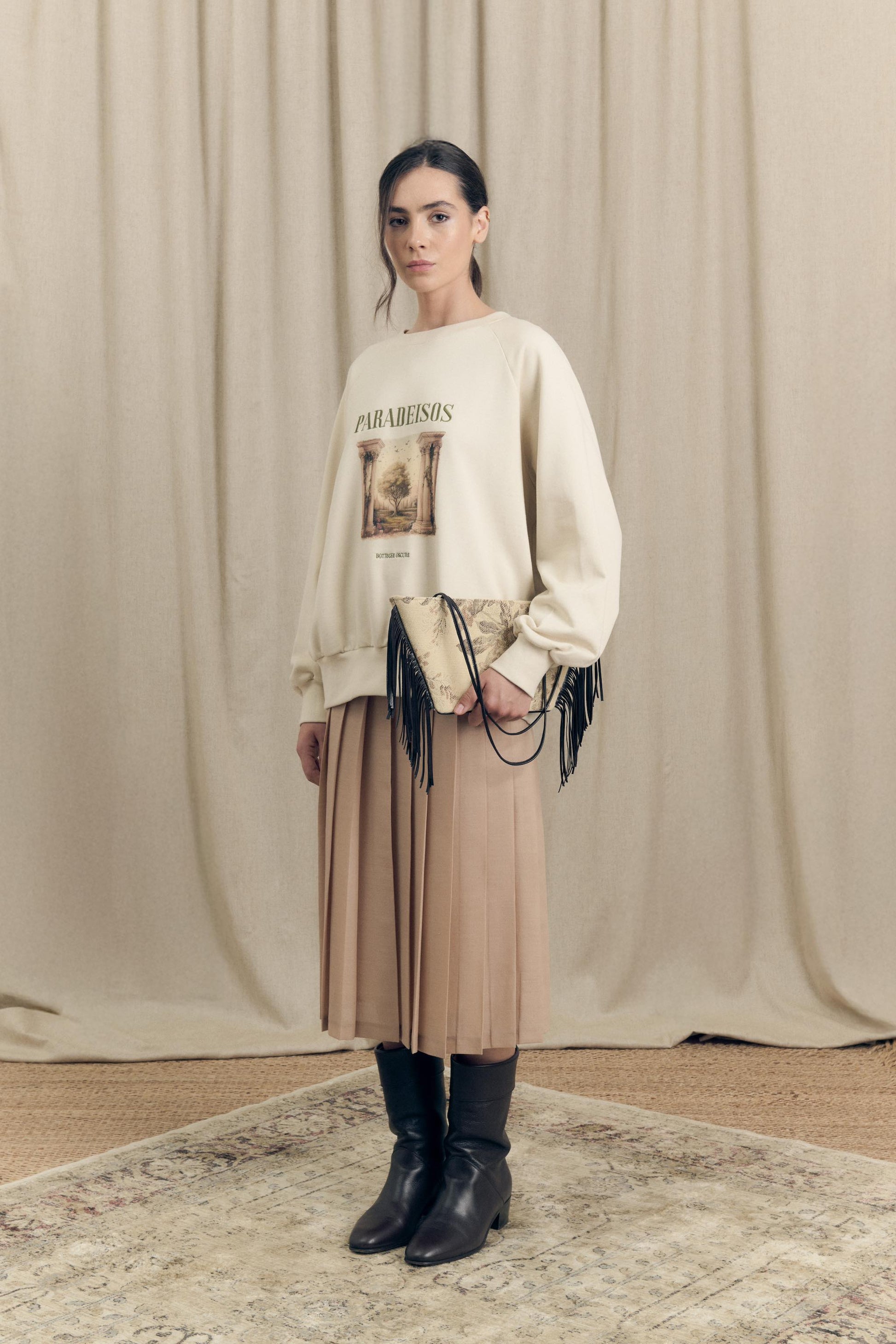 Model wearing oversized sweatshirt by Botteghe Oscure featuing exclusive Paradeisos print and embroidered lettering 