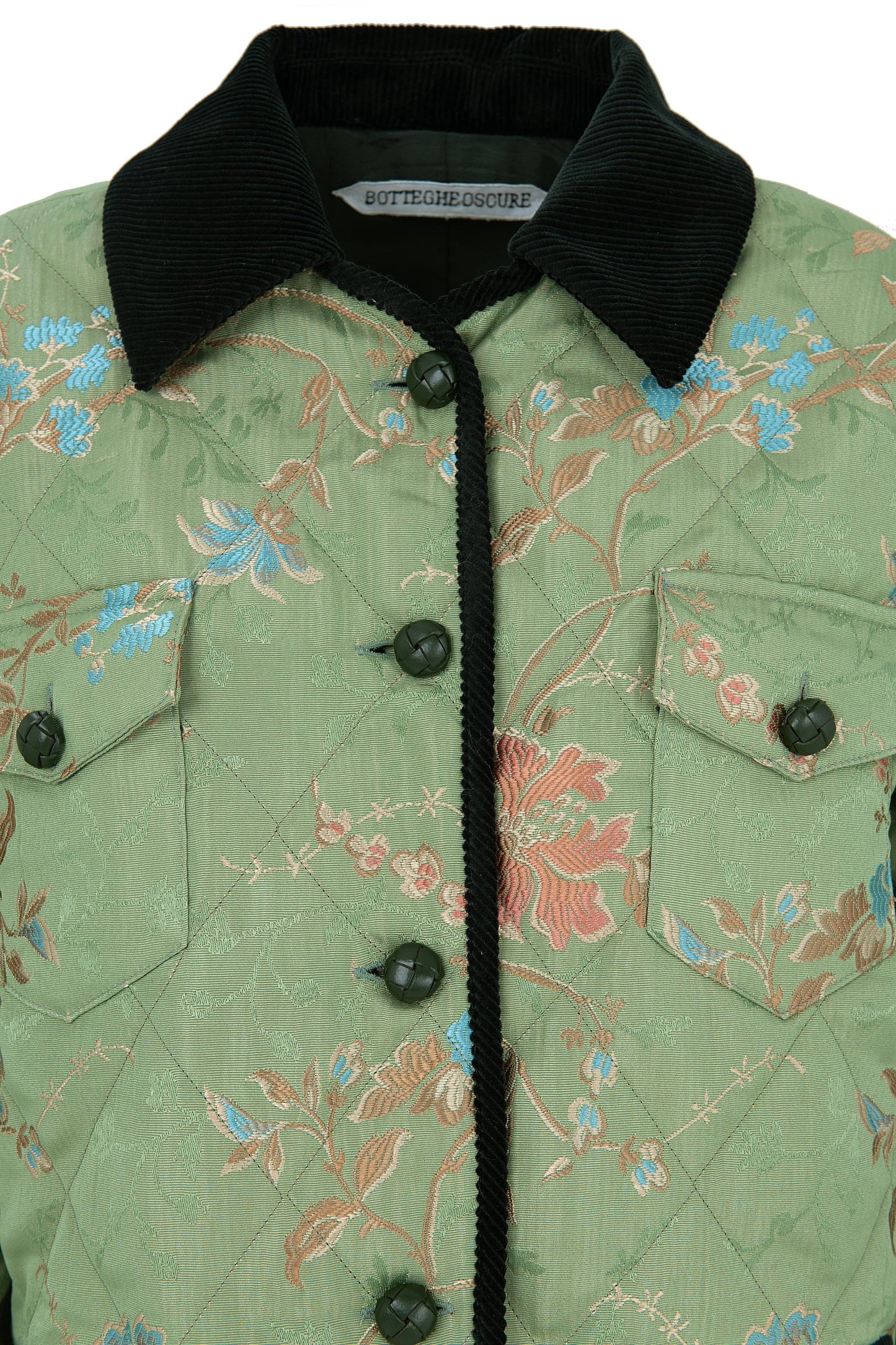 Close-up of the floral lampas cotton fabric and green velvet trims of the Botteghe Oscure quilted