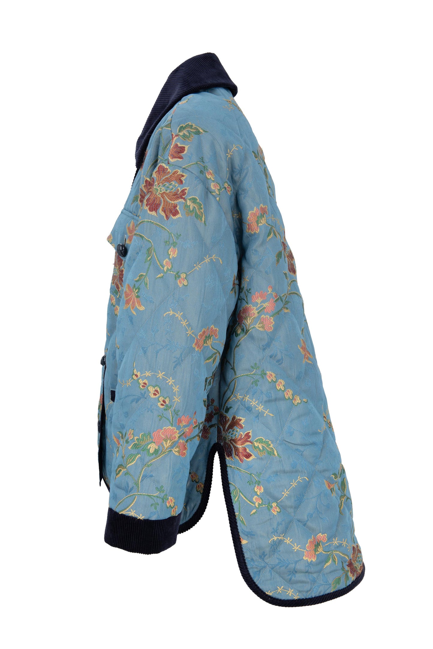 Side view of the blue floral quilted jacket with navy velvet collar and cuffs, by Botteghe Oscure.