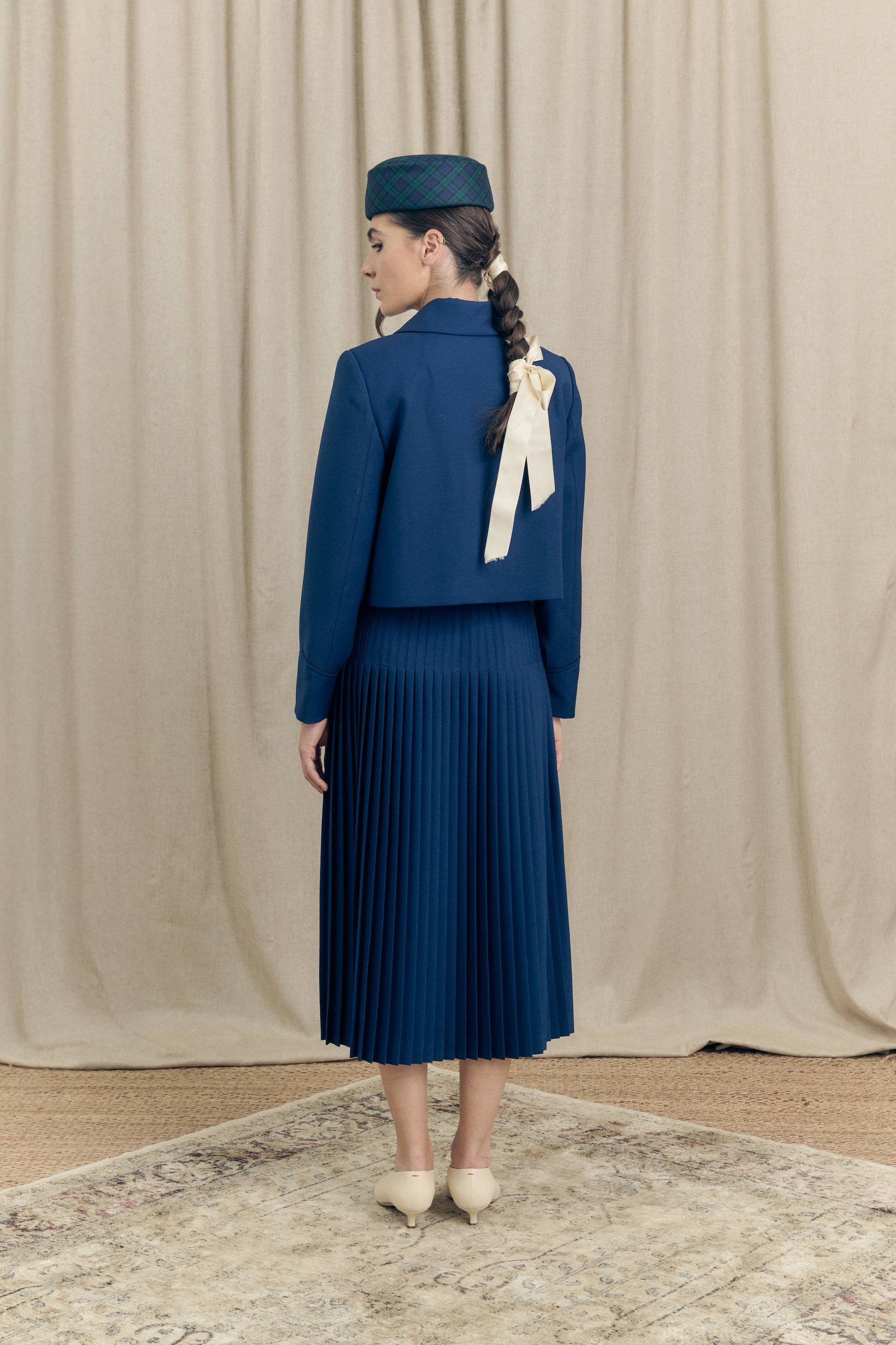 Botteghe Oscure look 19 Plissé Dos skirt movement showing back pleats.