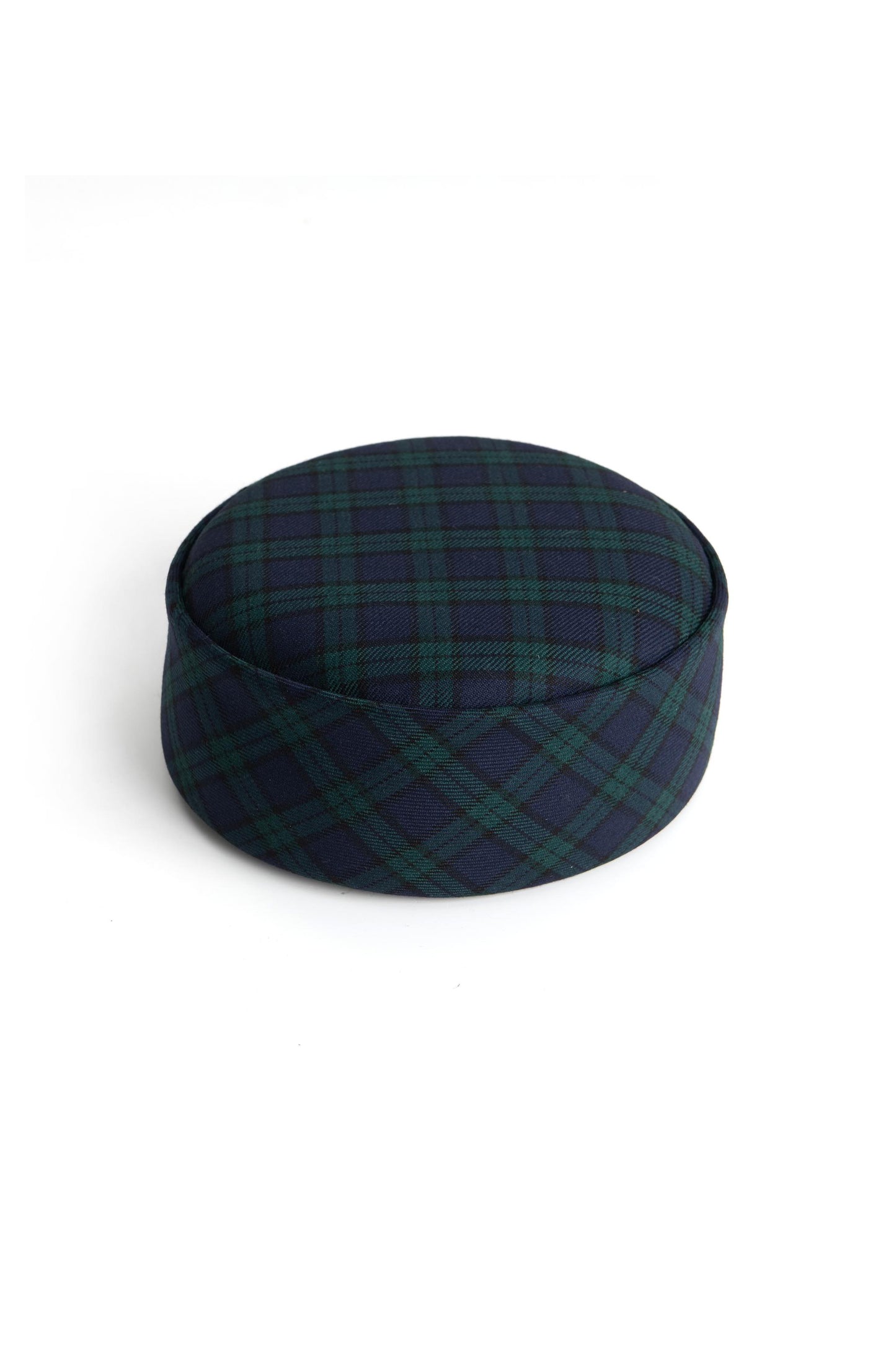 Top view of the Botteghe Oscure handcrafted pillbox hat in Black Watch tartan wool, showcasing its sculptural silhouette.
