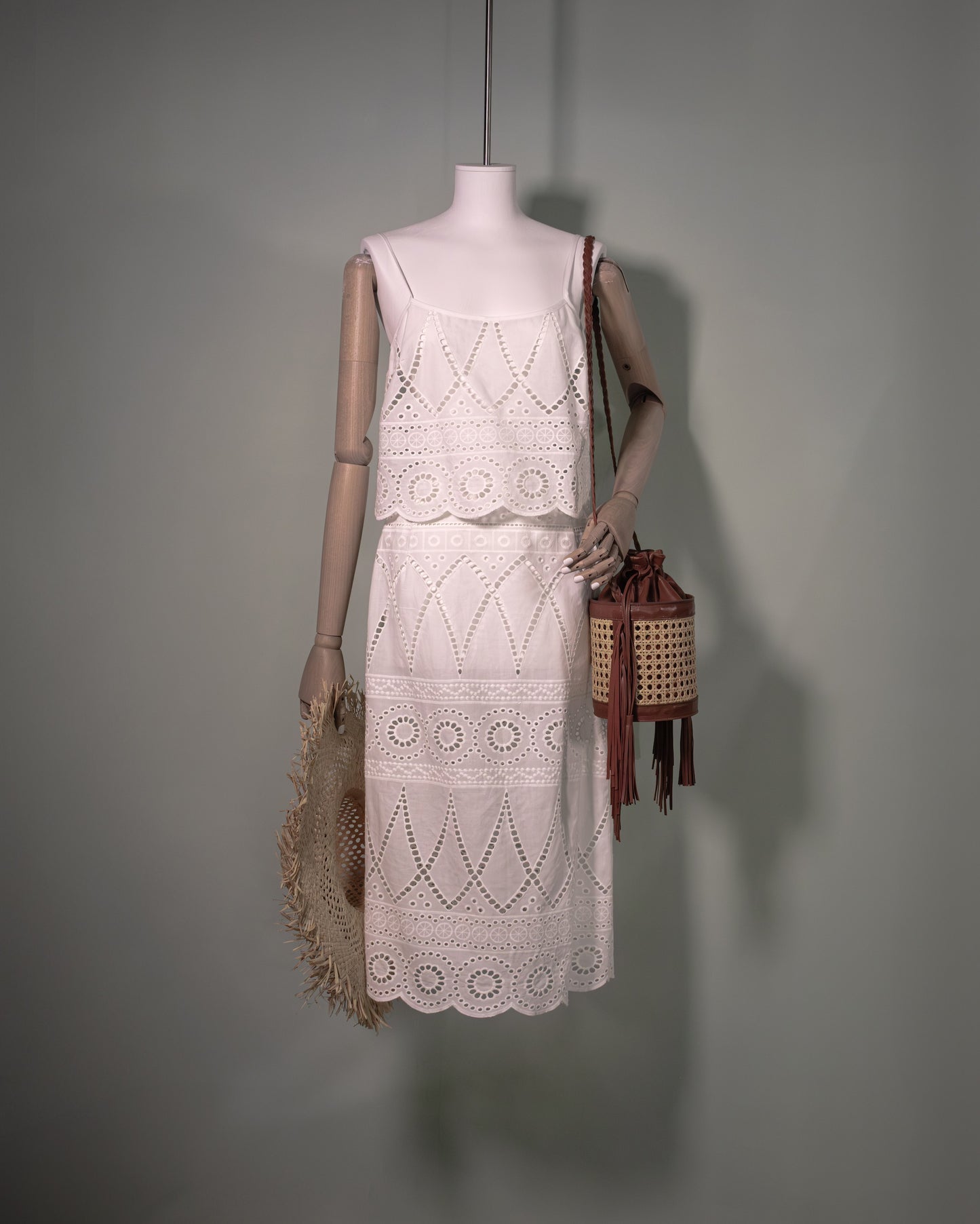 White cotton batiste top with broderie anglaise embroidery styled with the matching skirt and handcrafted bucket bag.