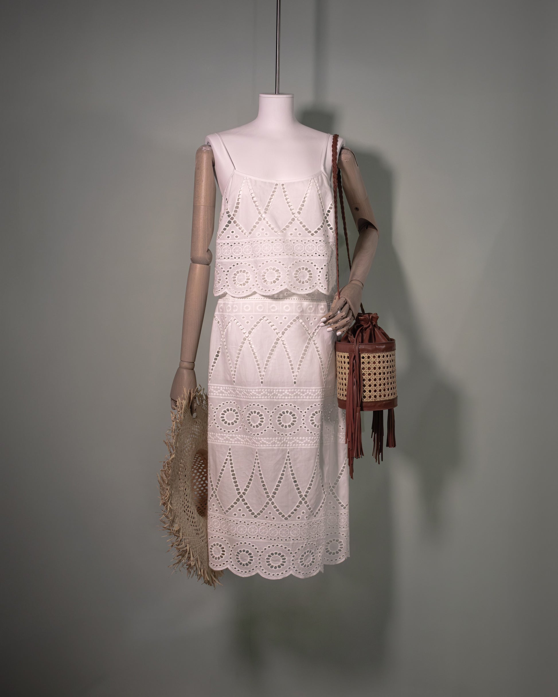 White cotton batiste top with broderie anglaise embroidery styled with the matching skirt and handcrafted bucket bag.