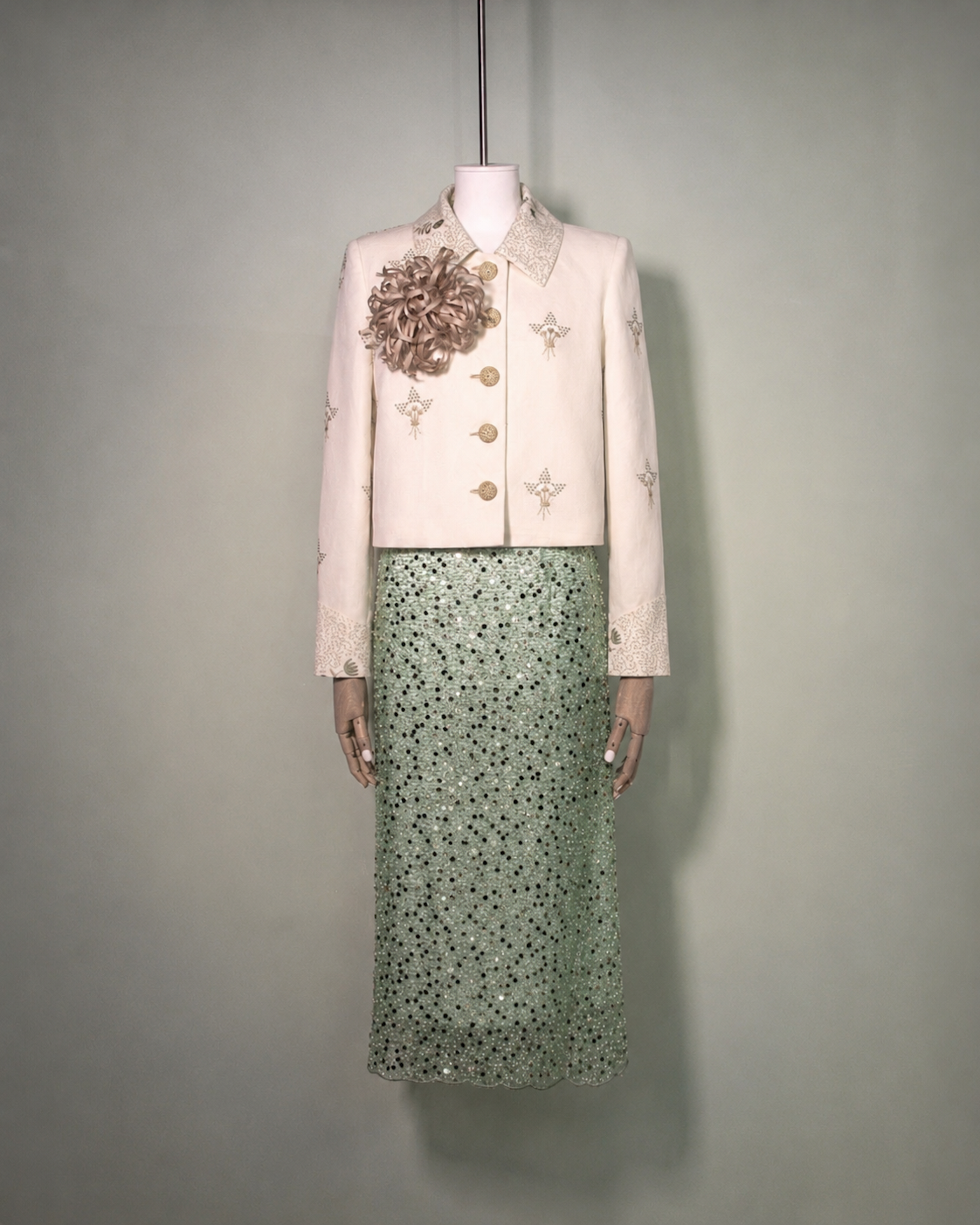 Botteghe Oscure Carré Jacket in archival English linen with hand-embroidered floral bouquets, styled with sequins embroidered skirt and silk flower brooch, front view.
