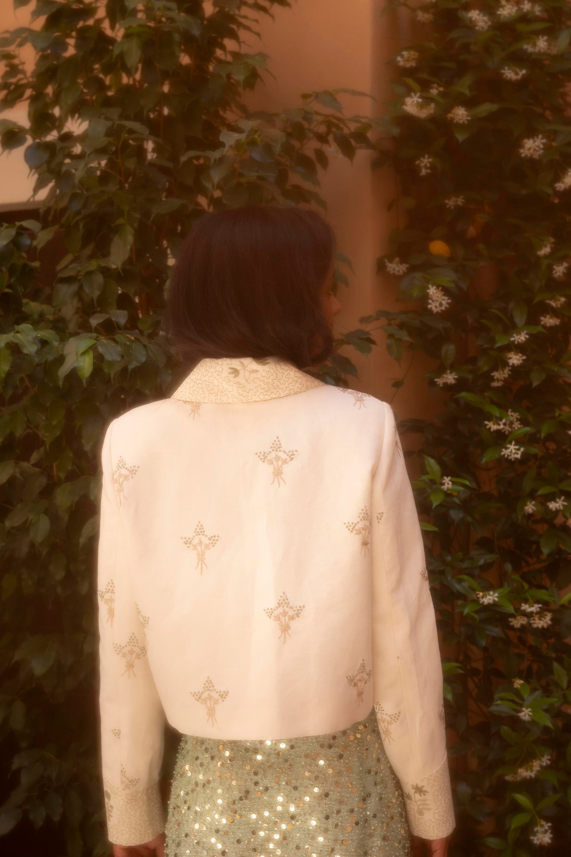 Botteghe Oscure Carré Jacket in archival English linen with hand-embroidered floral bouquets, styled in a complete editorial look, back view.