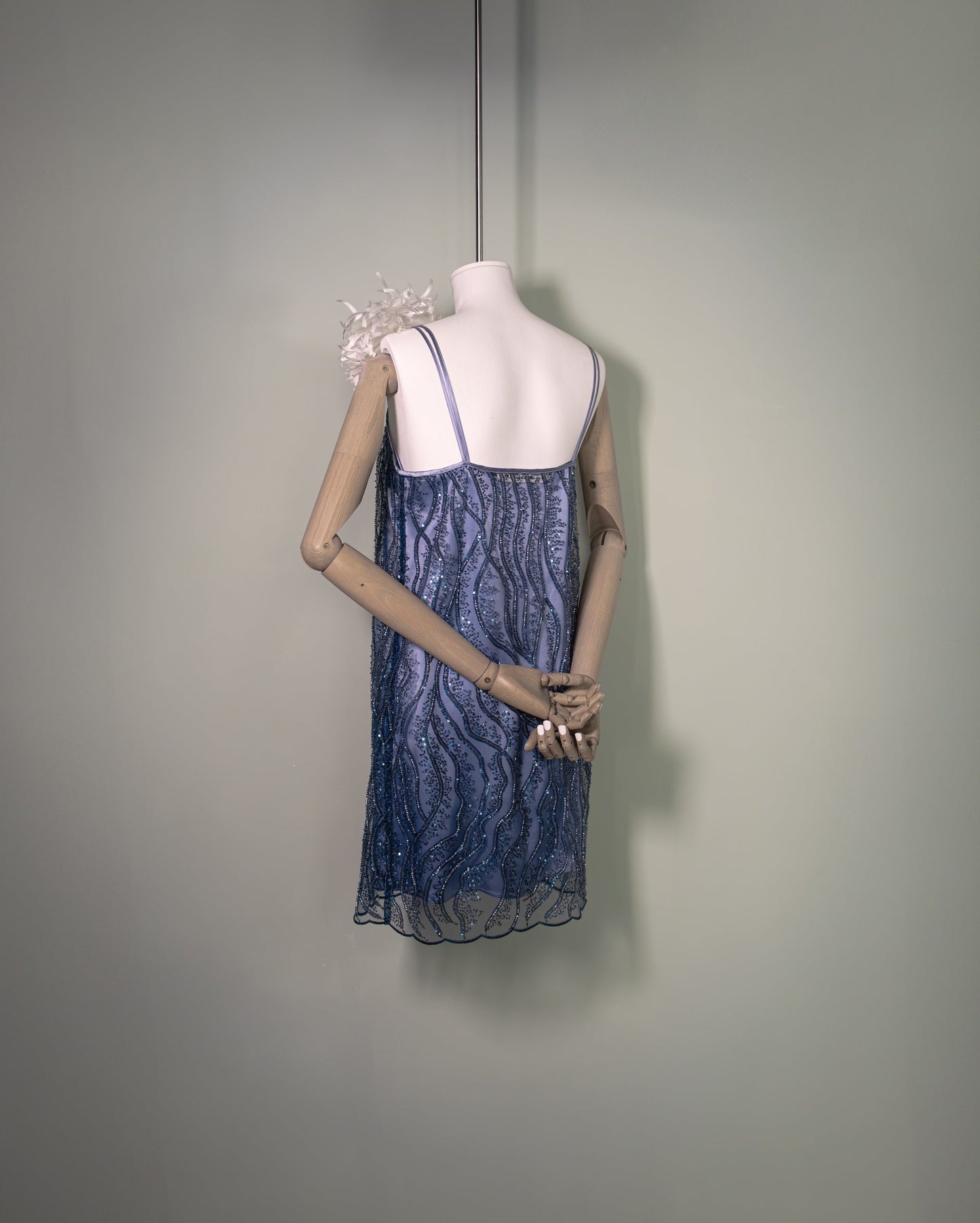 Botteghe Oscure embroidered tulle mini dress with wave-like pattern and silk satin straps, styled back view.