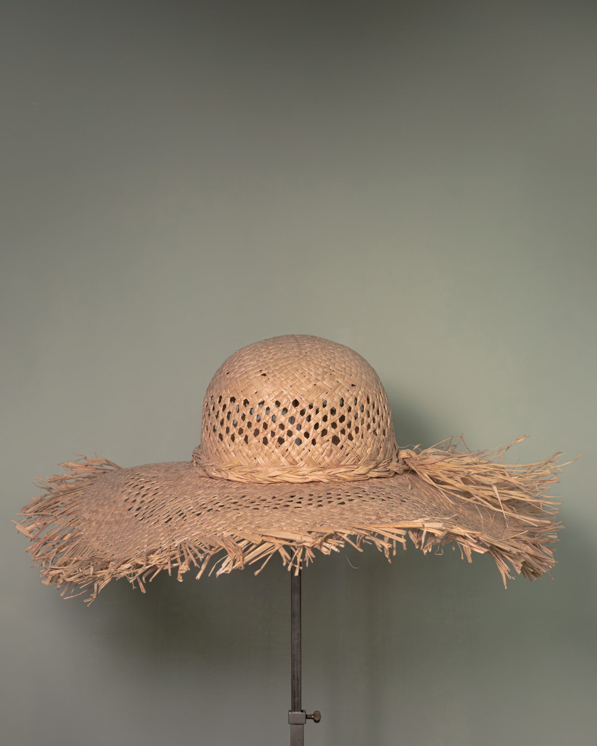 Handmade straw hat in Vienna straw with wide fringed brim, crafted in Tuscany by Botteghe Oscure.