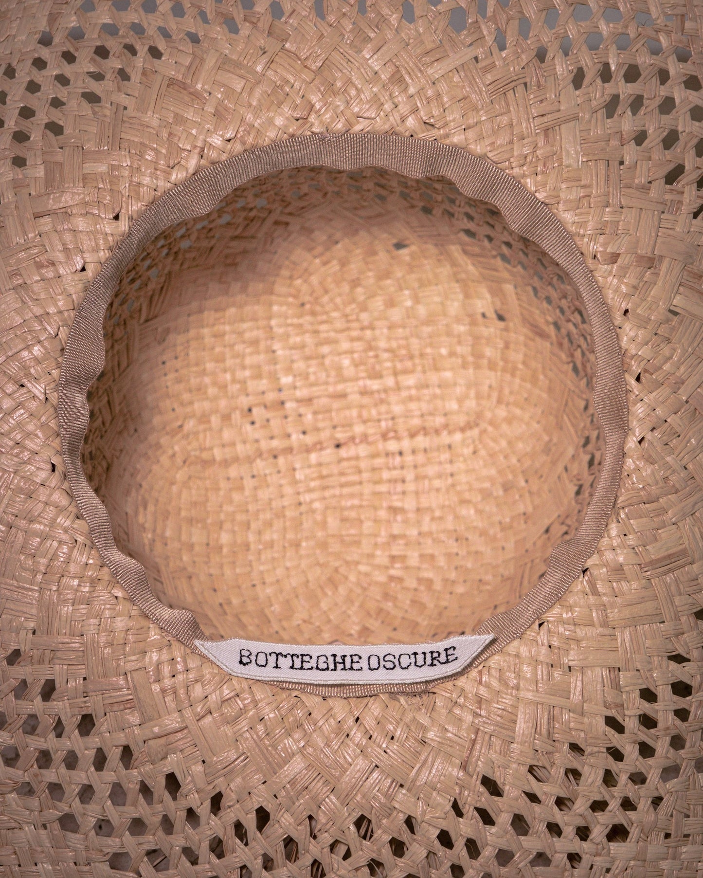 Interior view of handmade Vienna straw hat with grosgrain finish and Botteghe Oscure label.