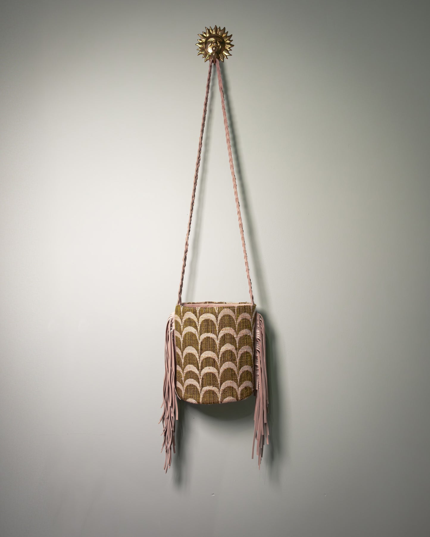 Front view of the Botteghe Oscure Palmette Archive Bucket Bag handcrafted from 1970s archive fabric with nubuck leather fringes.