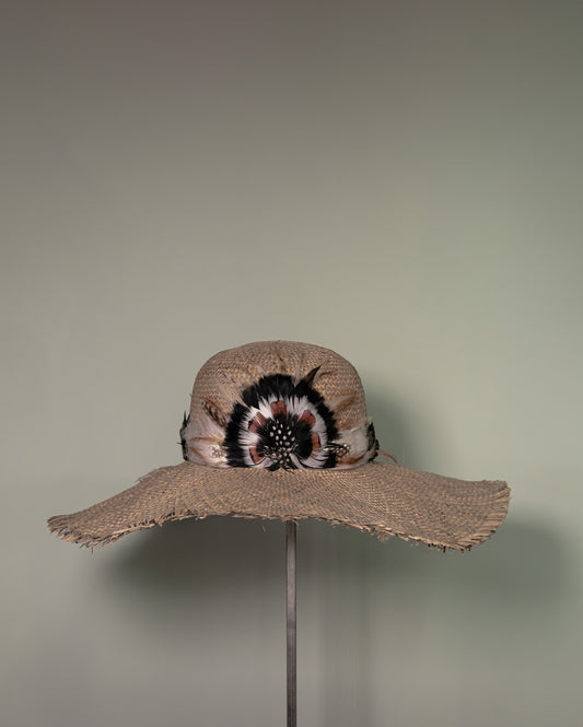 Handmade straw hat with feather embellishment crafted in Tuscany by Botteghe Oscure.