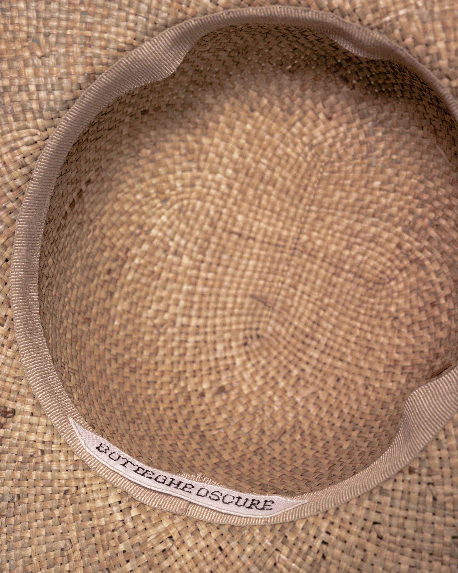 Interior of handmade straw hat with Botteghe Oscure label.
