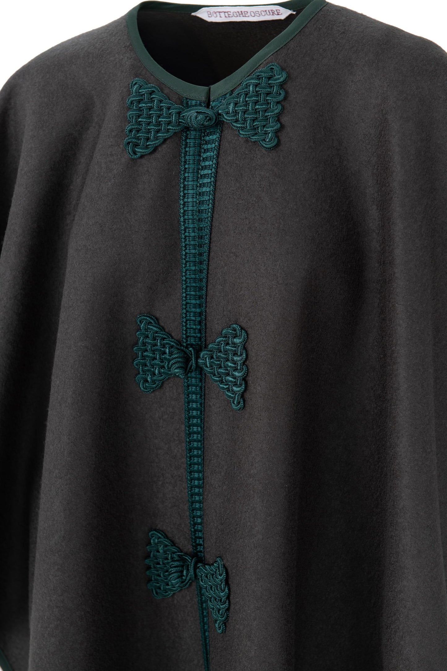 Detail of Botteghe Oscure Loden wool cape with handmade frogs and trimming