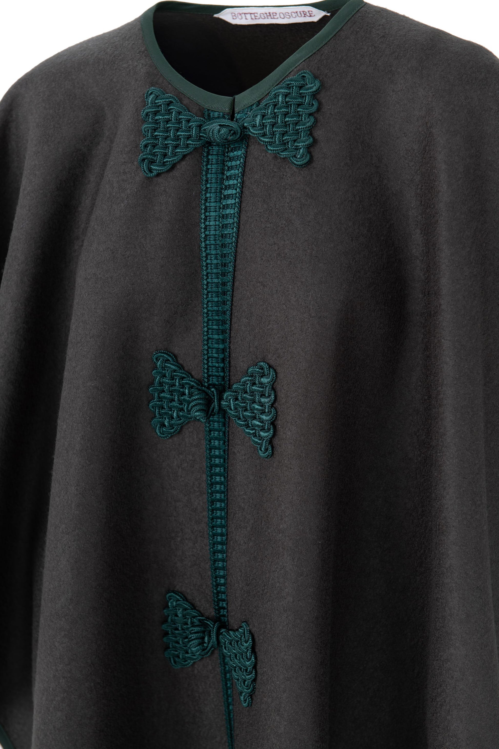 Detail of Botteghe Oscure Loden wool cape with handmade frogs and trimming