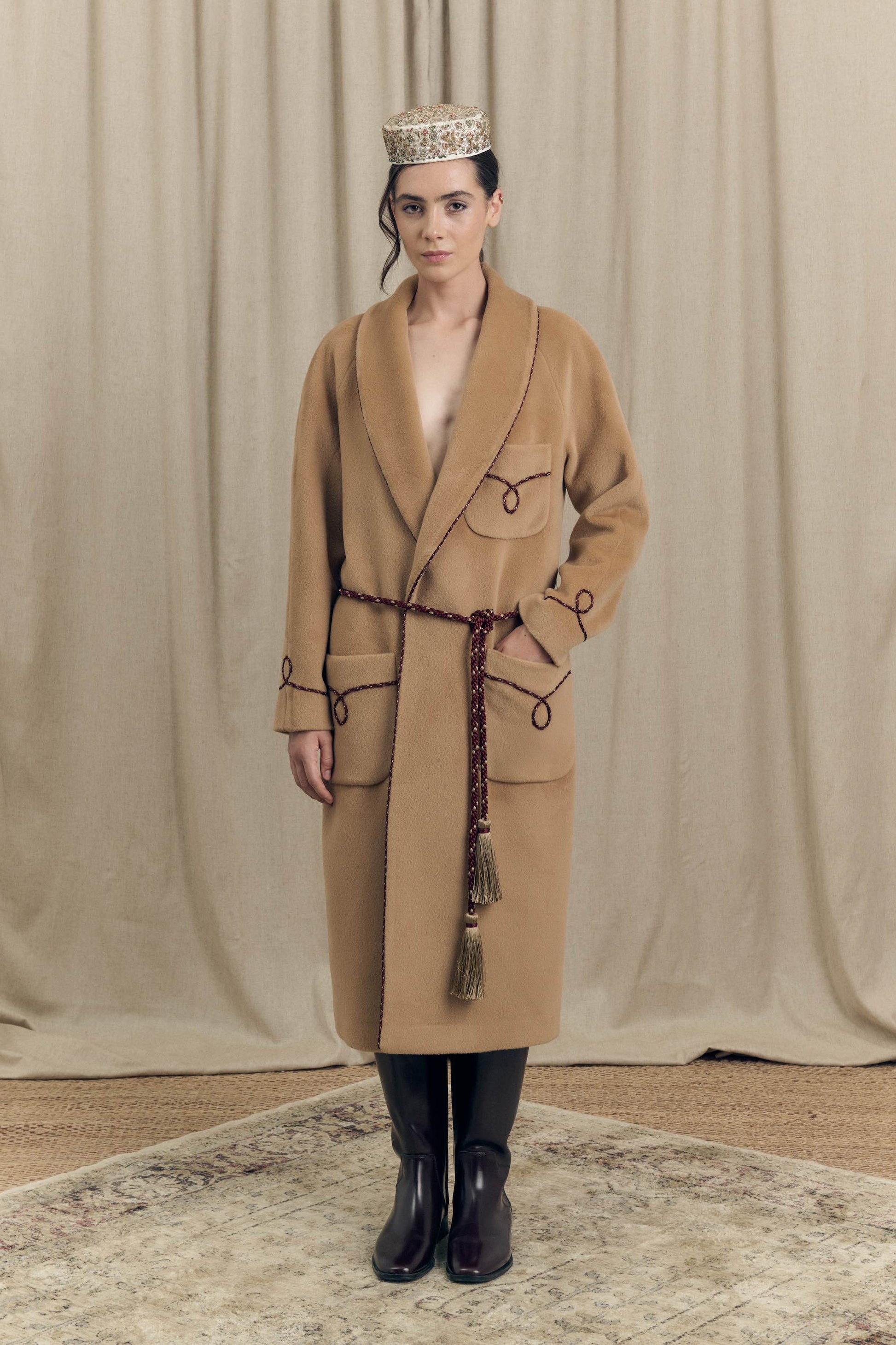 Camel combed wool wrap coat inspired by historic dressing gowns, front view, with bi-colour twisted cord details and perlé cord belt, Botteghe Oscure lookbook.