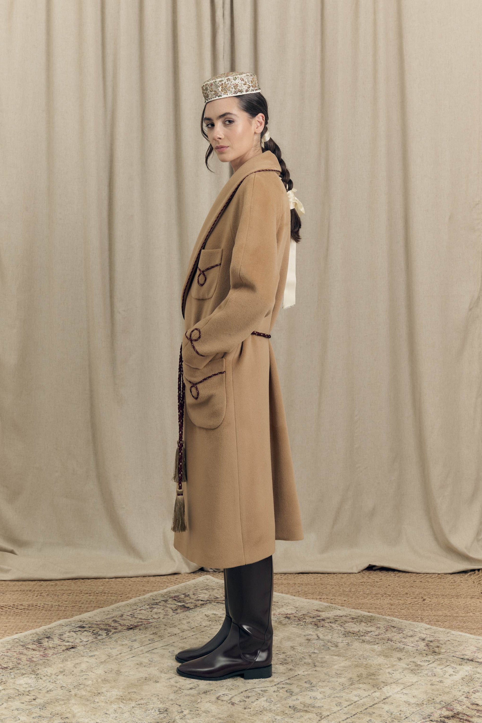 Side view of camel combed wool wrap coat with bi-colour twisted cord profiles and soft, enveloping silhouette, Botteghe Oscure lookbook.