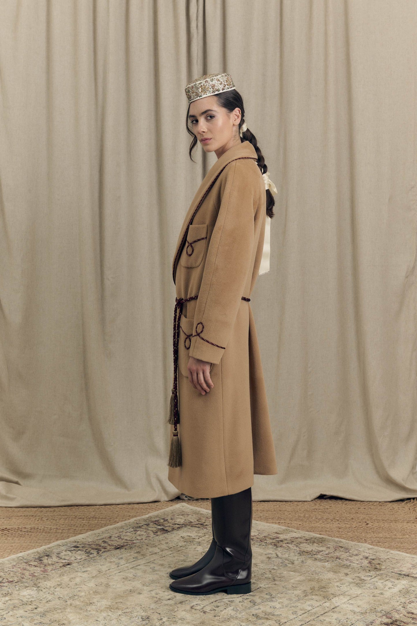 Side view of camel combed wool wrap coat with bi-colour twisted cord profiles and soft, enveloping silhouette, Botteghe Oscure lookbook.