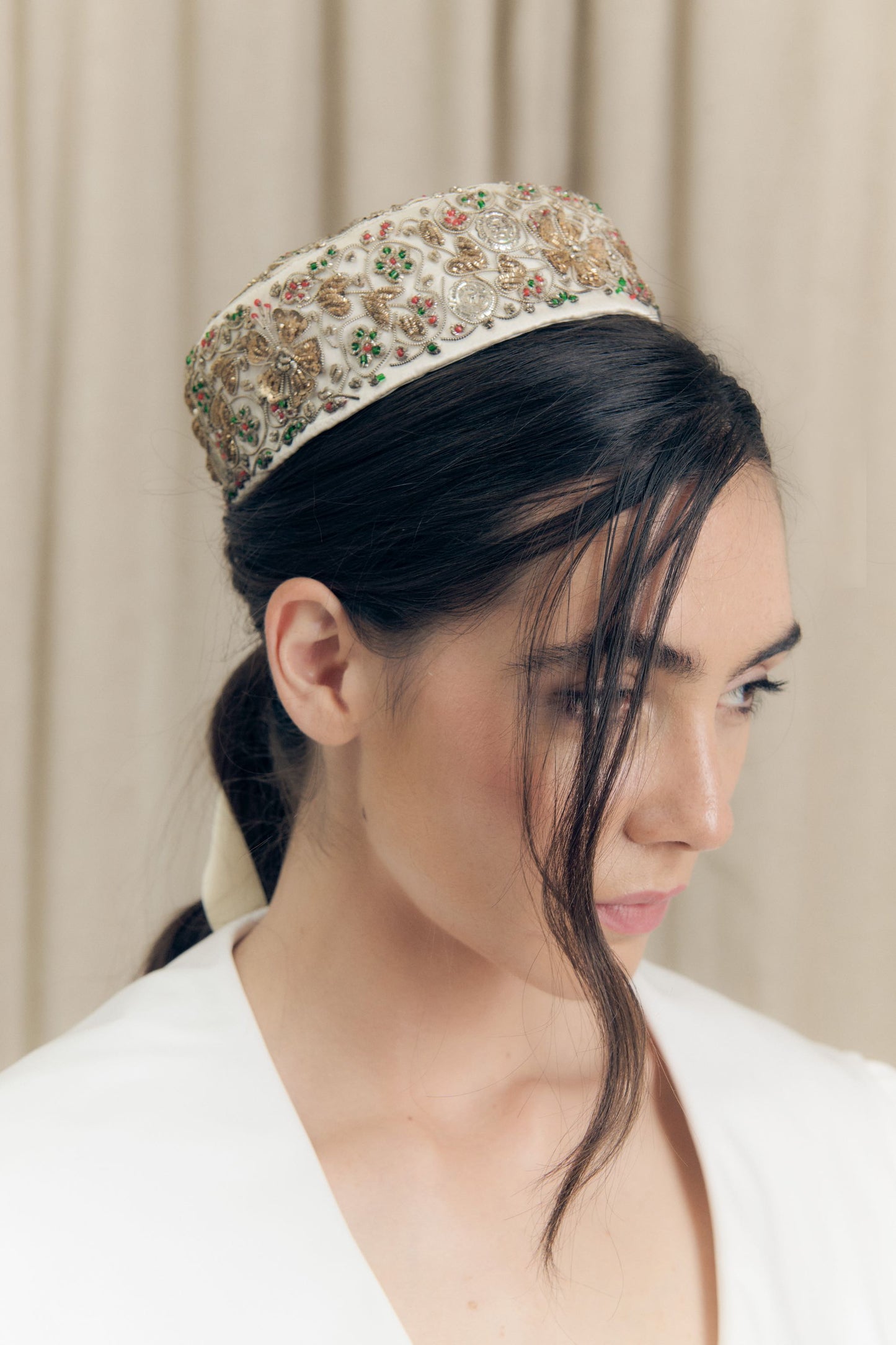 Smoking hat  by Botteghe Oscure in vintage silk with hand-applied zardozi embroidery, worn on model, inspired by late 19th-century chamber hats.