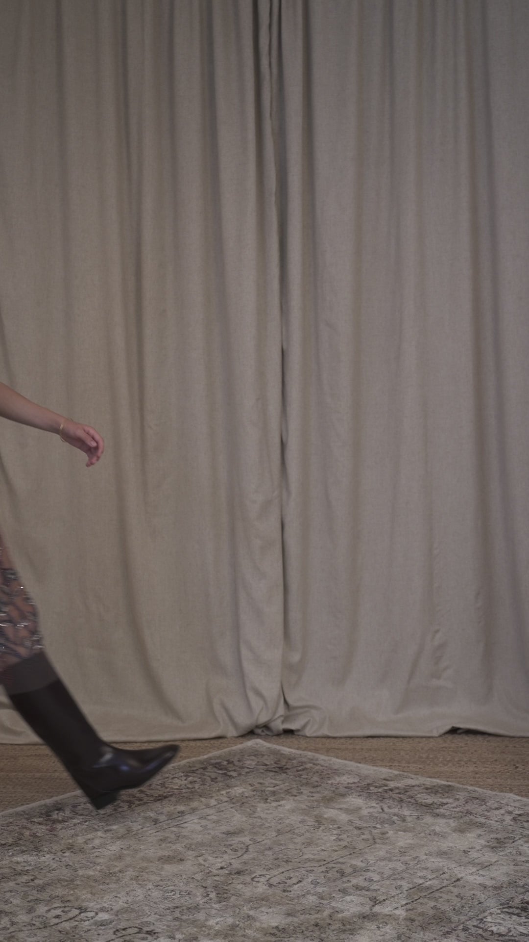 Model walking in Botteghe Oscure vintage hand-embroidered tulle skirt and tank top with floral motifs, worn back view, sheer layered design.