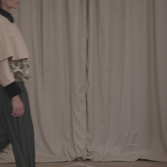 Video of model wearing the Heatherfield Jacket by Botteghe Oscure, highlighting the slightly flared silhouette, removable capelet, and refined mix of floral jacquard and dark green velvet detailing.