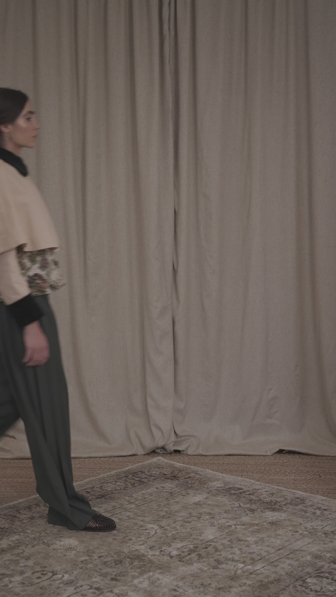 Video of model wearing the Heatherfield Jacket by Botteghe Oscure, highlighting the slightly flared silhouette, removable capelet, and refined mix of floral jacquard and dark green velvet detailing.