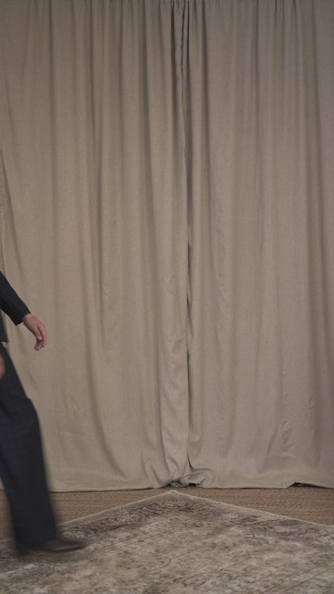 Model walking in belted military blazer and matching Black Watch tartan trousers by Botteghe Oscure.